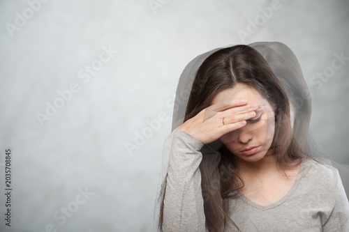 Fotografija Sad woman suffering from pain feeling dizzy