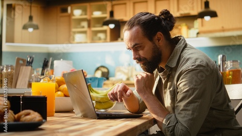 Photos Uncertain person frowning at the laptop screen and being disoriented, confused with his online work and management tasks, Ambiguous misunderstanding information and man in doubt