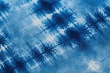 Blue and white tie dye fabric shows abstract patterns created by hand. Textile has textured, organic, and freeform design. Clothing material has unique artistic look.