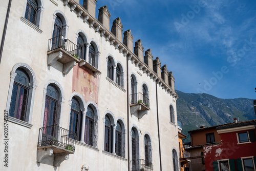 Historic Italian building with mountain backdrop near Lake Garda.