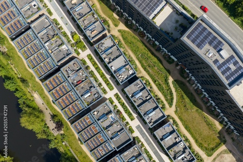 Tableau sur toile Top down aerial drone view of modern canal side apartments with rooftop solar pa