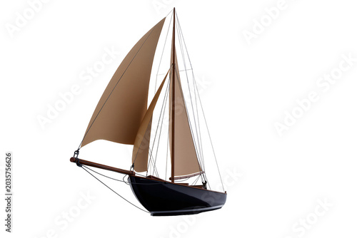 Photos Isolated classic model sailboat with brown sails and dark hull for maritime adve