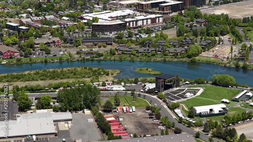 Aerial of Deschutes River through downtown Bend Oregon in spring with amphitheater on sunny day