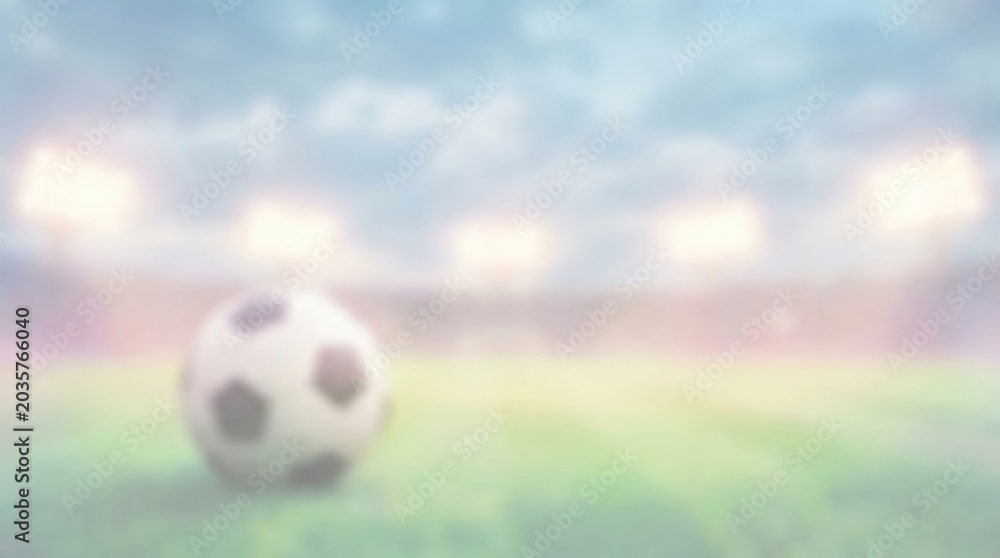 Naklejka premium Blurred Soccer Ball on Stadium Grass Field with Bright Floodlights for Sports Concept Background and Copy Space