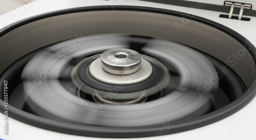 Close-up view of a laboratory centrifuge spinning at high speed, creating motion blur during scientific analysis