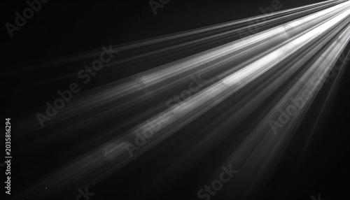 Bright white light rays shining diagonally through a dark, smoky or dusty atmosphere, creating a dramatic and ethereal effect.