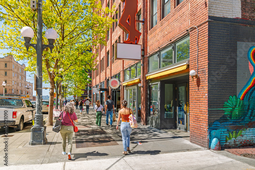 Pedestrians walk along Pine Street in downtown Seattle, Washington, just down the street from Pike Place Market on the way to the Seattle Waterfront