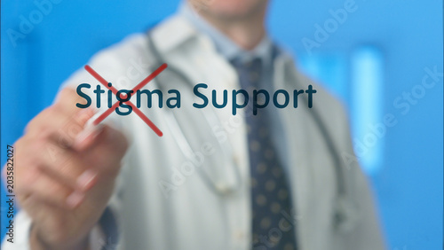 Schilderij op canvas Doctor eliminating the word stigma with a red cross mark while highlighting supp