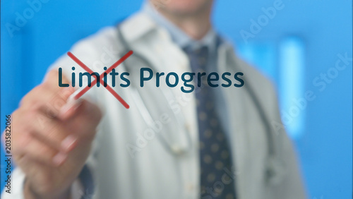 Healthcare professional indicating a red cross out mark over the word limits and presenting the word progress on a virtual screen, symbolizing overcoming obstacles in medicine