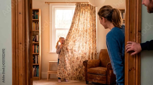 Family Playful Hide-and-Seek in Cozy Home Living Room on Sunny Day