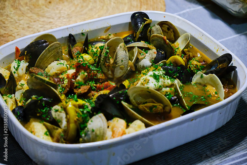 Принти на полотні Clams and mussels cocked in a ceramic dish.
