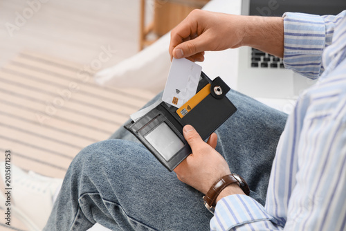 Man putting credit card int...