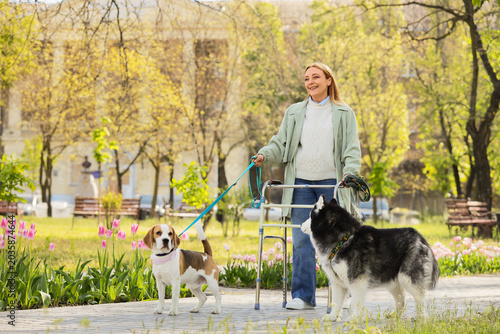 Mature woman with dogs usin...