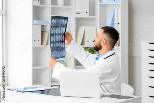 Male doctor studying MRI sc...