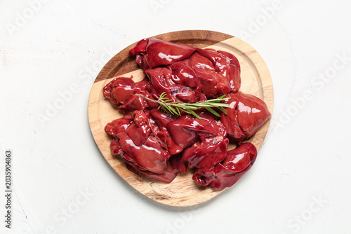 Wooden board with raw liver...