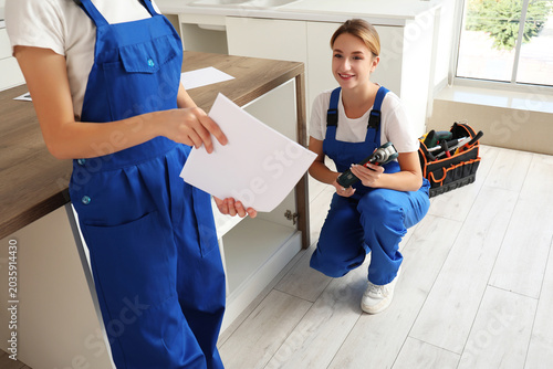 Female workers with instruc...