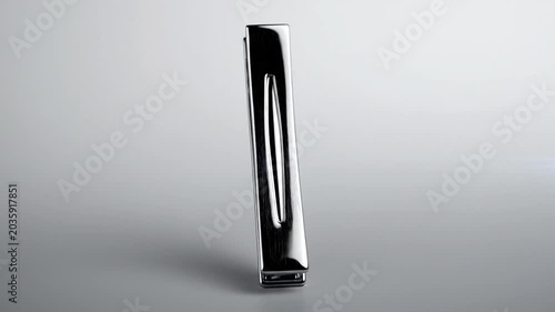 Polished silver metal tie clip on grey background