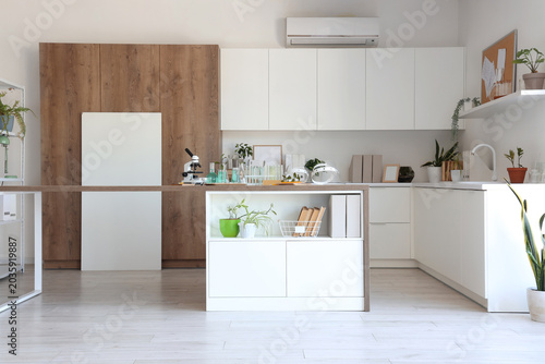 Interior of light medical laboratory with tables and houseplants