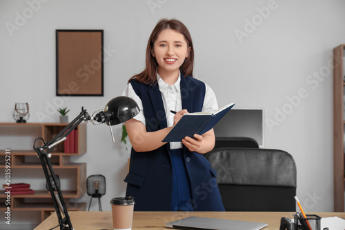Pretty businesswoman with c...
