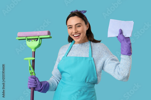 Cheerful woman with mop and...