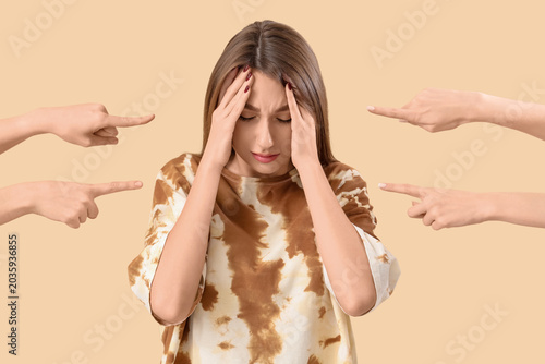 Photos People pointing at stressed young woman on beige background
