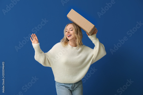 Young woman with cardboard ...
