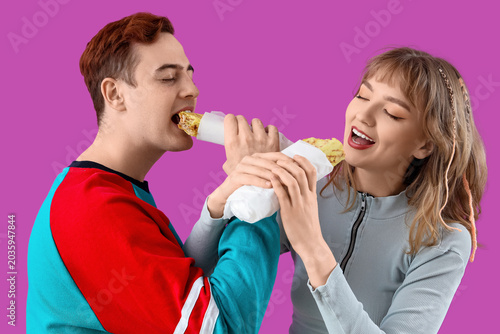 Young couple eating tasty s...