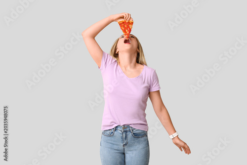 Young woman eating piece of...
