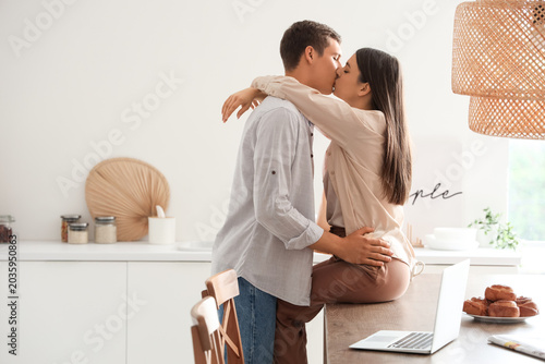Happy young couple kissing ...