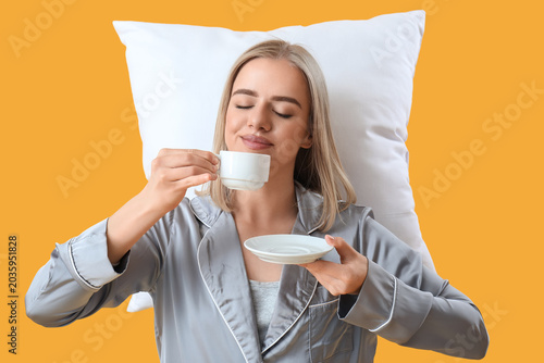 Happy young woman in pajama...