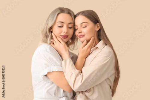 Young sisters hugging on be...