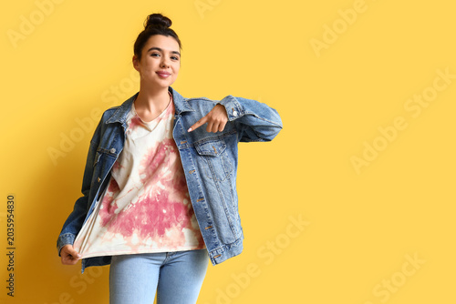Young woman pointing at tie...