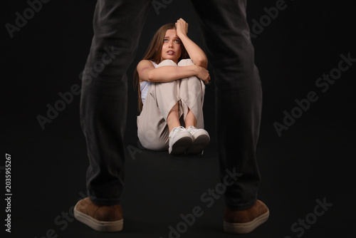 Bruised young woman and her...