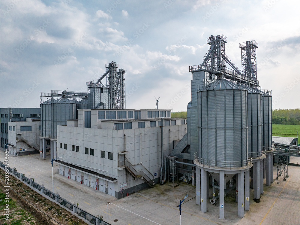 Fototapeta premium Modern grain silos and industrial factory buildings for storage and processing