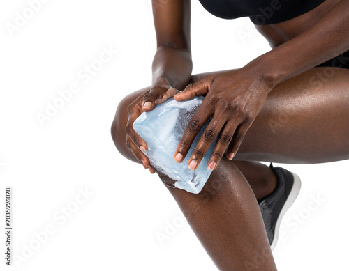 partial view of sportswoman using ice for knee isolated on transparent or white background
