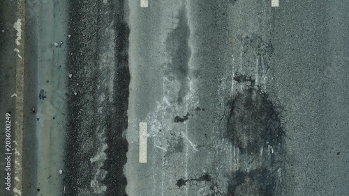 Fényképezés A top-down shot captures an road with visible cracks, spotlighting public works challenges, safety threats, resource allocation, aging infrastructure, environmental consequences, and overdue repairs