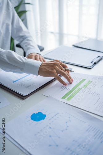 Busy businessman checking document in office