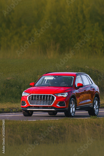 Fotografie Compact crossover driving on countryside road