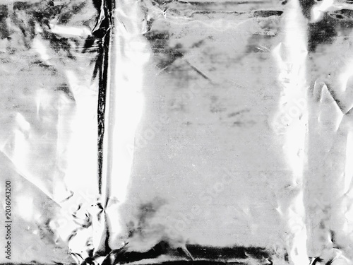 Abstract aluminum texture showing folds, highlights, and deep shadows.