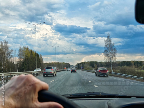 Windshield view of road and traffic during solo travel by car while navigating through the landscape