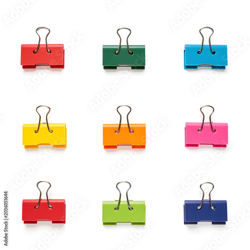 colorful binder clips organized in row isolated