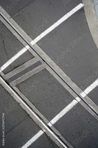 An abstract aerial view of several road systems converging, lines and tracks on the road