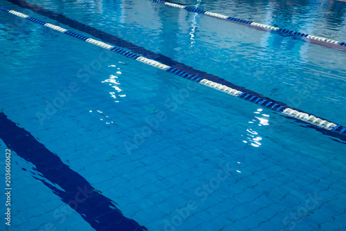 Photos Cool blue water shimmers under soft lighting in this indoor swimming pool, creating a serene atmosphere perfect for relaxation and leisure
