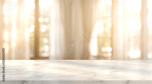 Marble table top on blurred bright living room window background with sun light for luxury product display mockup.