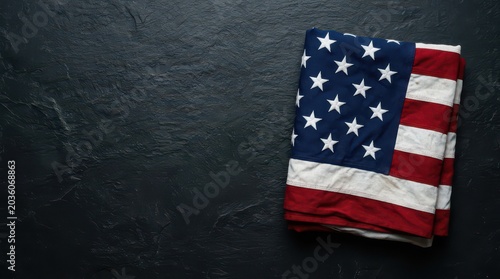 Folded american flag on a dark textured stone background united