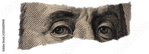 Close-up of Benjamin Franklin's Eyes on Torn Dollar Bill