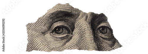 Close-up of Benjamin Franklin's Eyes on Torn Dollar Bill