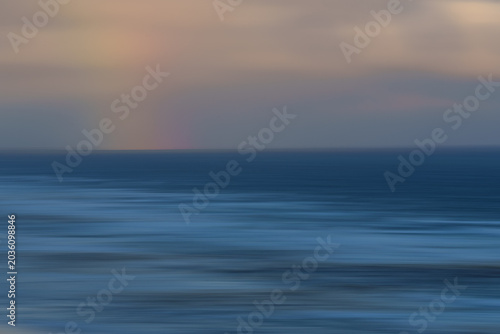Photos Coastal impressionist seascape with wave textured view to horizon with hint of r
