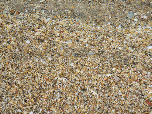 Clear Shallow Water Over Pebble Beach With Gentle Ripples And Sunlit Stones At Shoreline