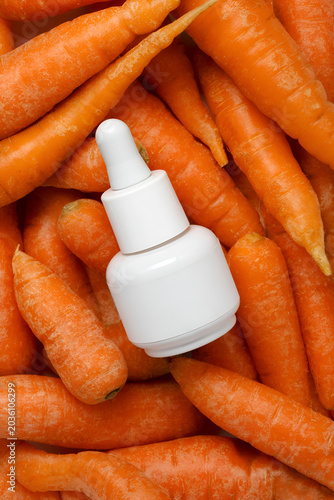 White Dropper Bottle Serum On Fresh Carrots Flat Lay - Natural Skincare Cosmetic Mockup